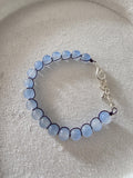 Blue glass bead bracelet with metal braid