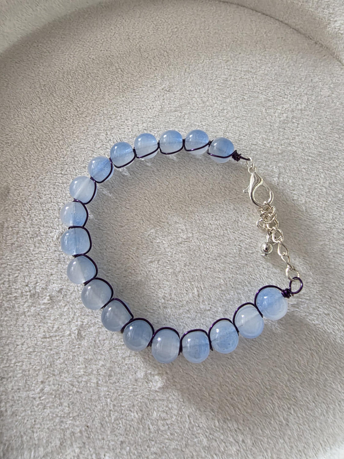Blue glass bead bracelet with metal braid